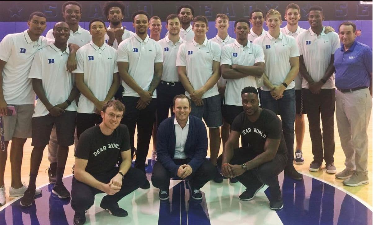 Robert X. Fogarty with a team wearing Dear World shirts